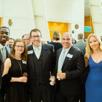 Marcus Wallace, Erika Wallace, Jodi Chycinski, and guests at the Enrichment Dinner
